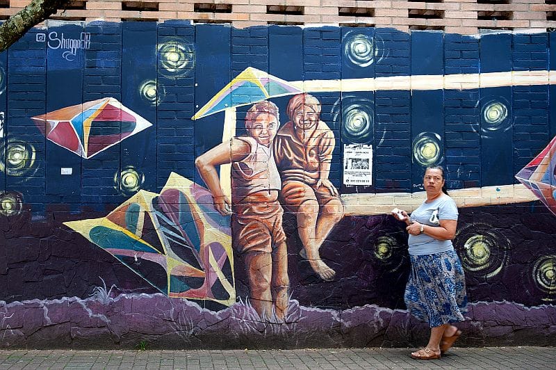 Local women of the Comuna 13 in Medellin in front of Street Art